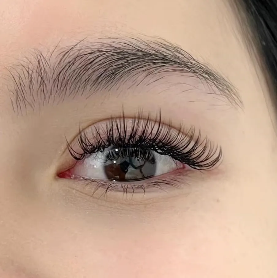 Hybrid lash extensions at Sugaring NYC McKinney — full, wispy lash set result
