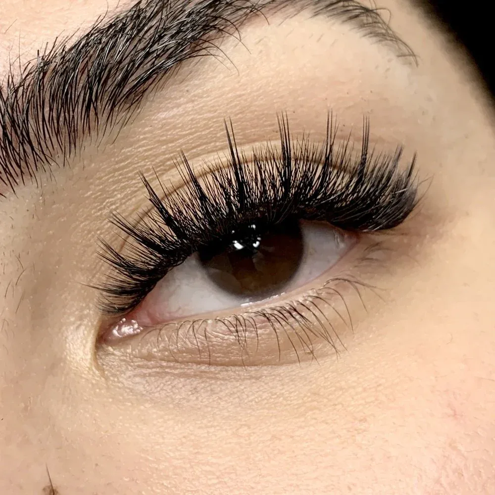 Hybrid lashes at Sugaring NYC McKinney — textured, open-eye lift result