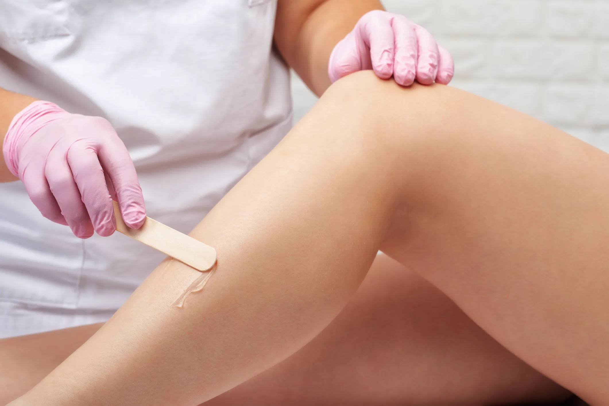 Licensed esthetician performing professional waxing service at Sugaring NYC McKinney studio in McKinney TX